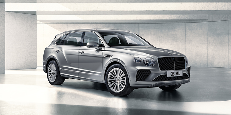 Bentley Roma Bentley Bentayga Extended Wheelbase SUV front three quarter in Moonbeam paint with a grey background